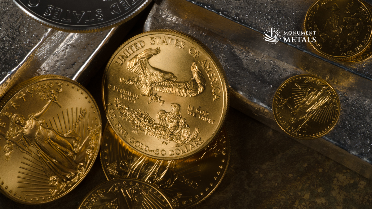 Close-up of American Gold Eagle coins arranged on stacked silver bars, highlighting detailed coin designs and reflective metal surfaces with Monument Metals logo visible.