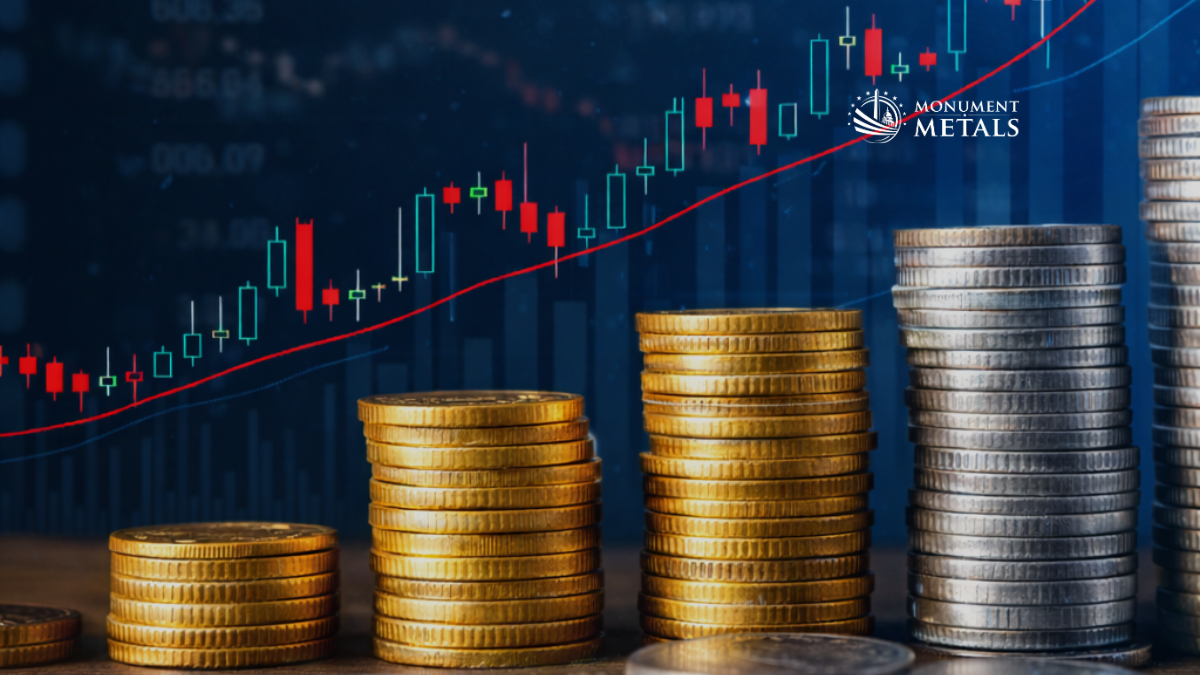 Increasing stacks of gold and silver coins arranged in ascending order in front of an upward-trending market chart, illustrating growth in precious metals prices, with Monument Metals logo.
